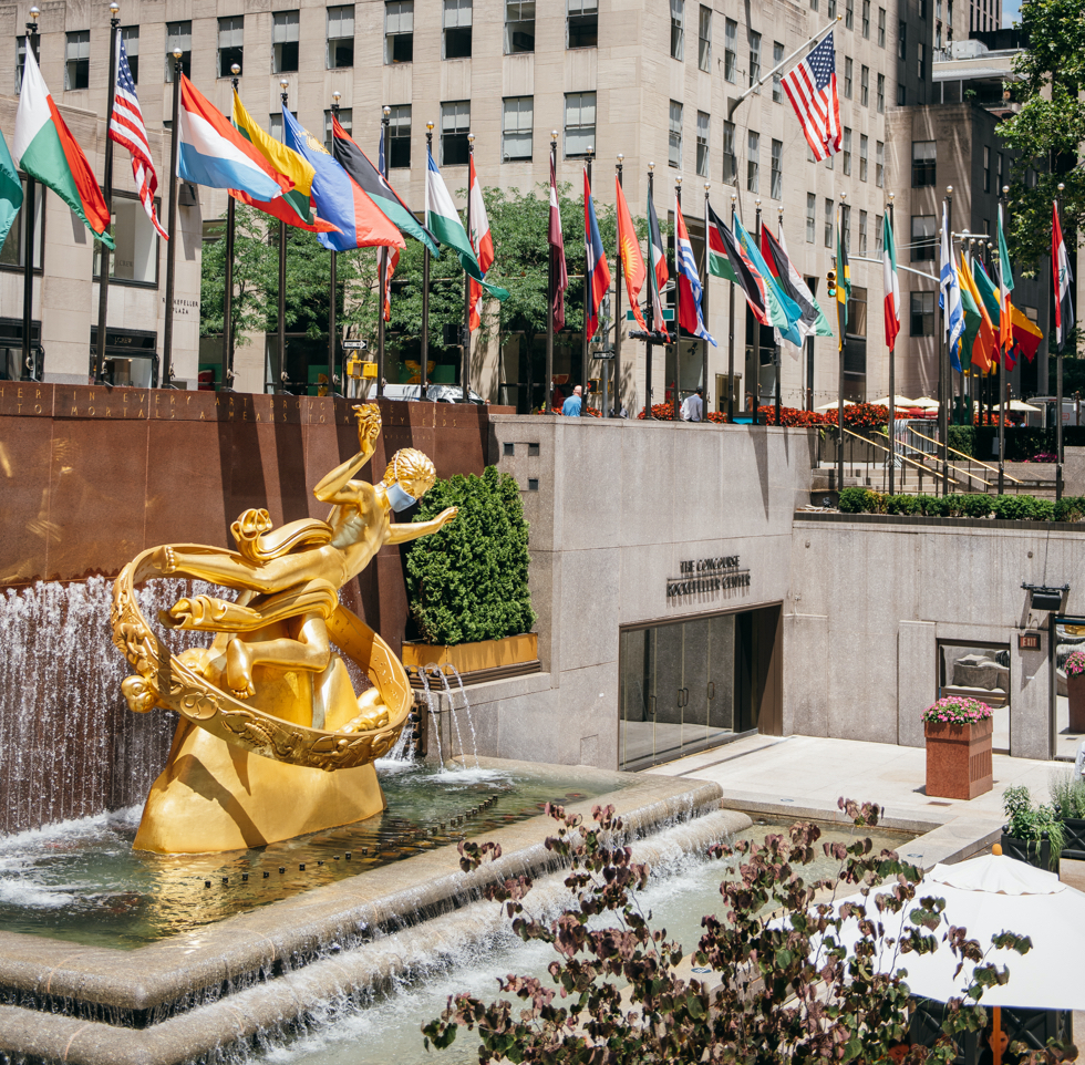 The Prometheus statue, wearing a mask, overlooking the sunken plaza.