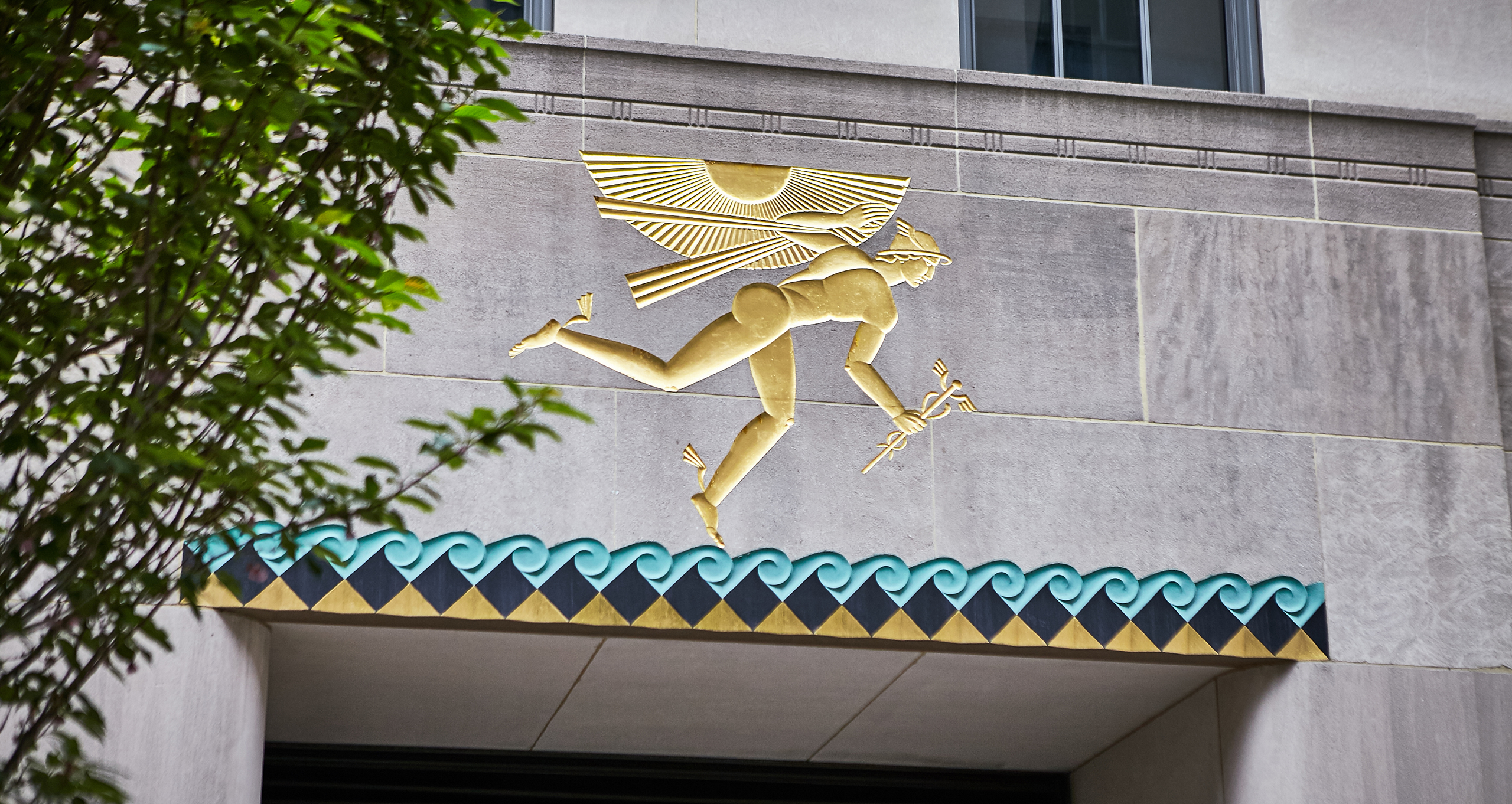 Photograph of Winged Mercury relief from Channel Gardens of 620 Fifth Avenue